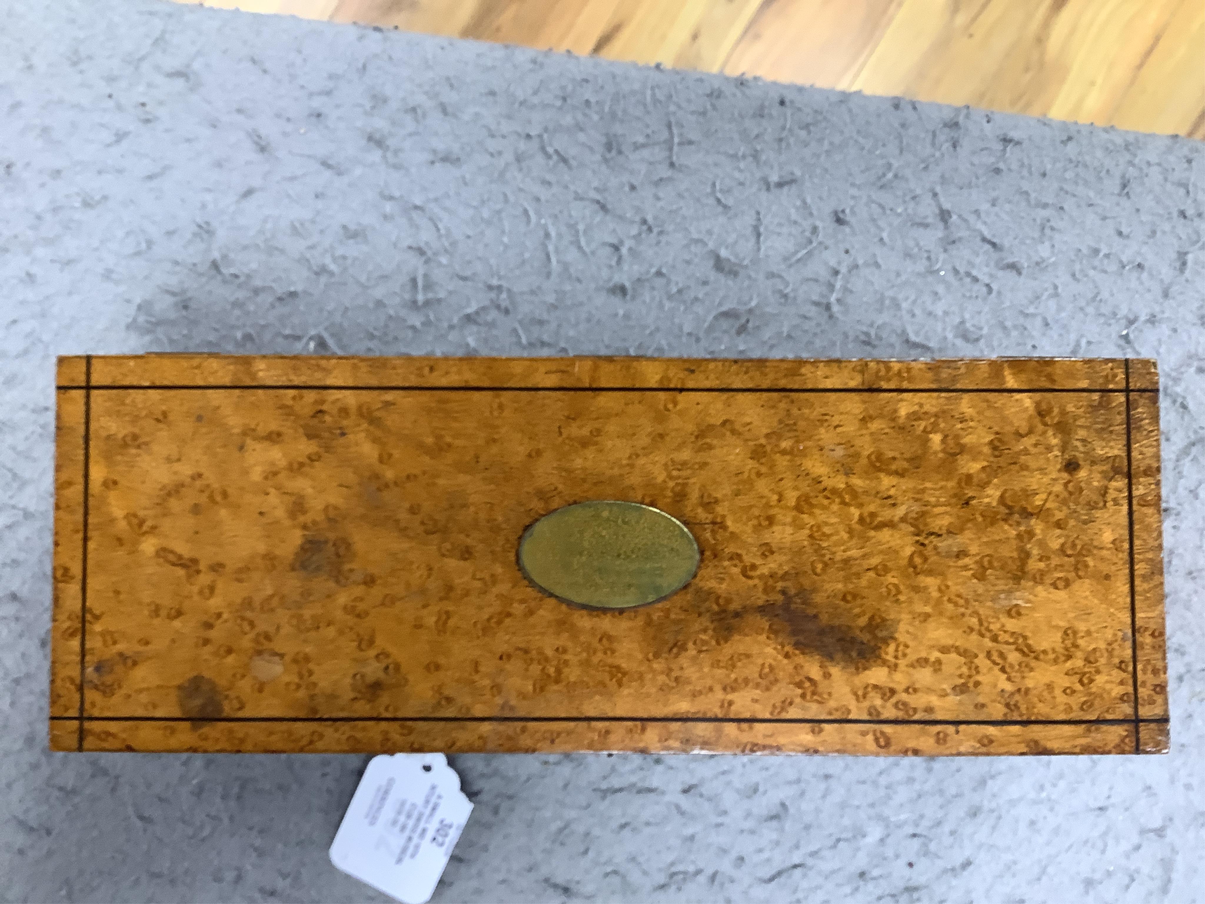 A small mid 19th century Swiss musical box in a bird’s eye maple case, side key wound, 30cm wide. Condition - fair.